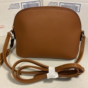 Cognac faux leather cross body bag with coordinating tassel. Cute New item!